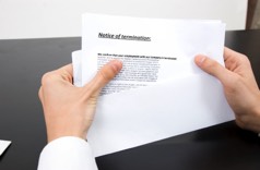 man holding termination letter and envelope